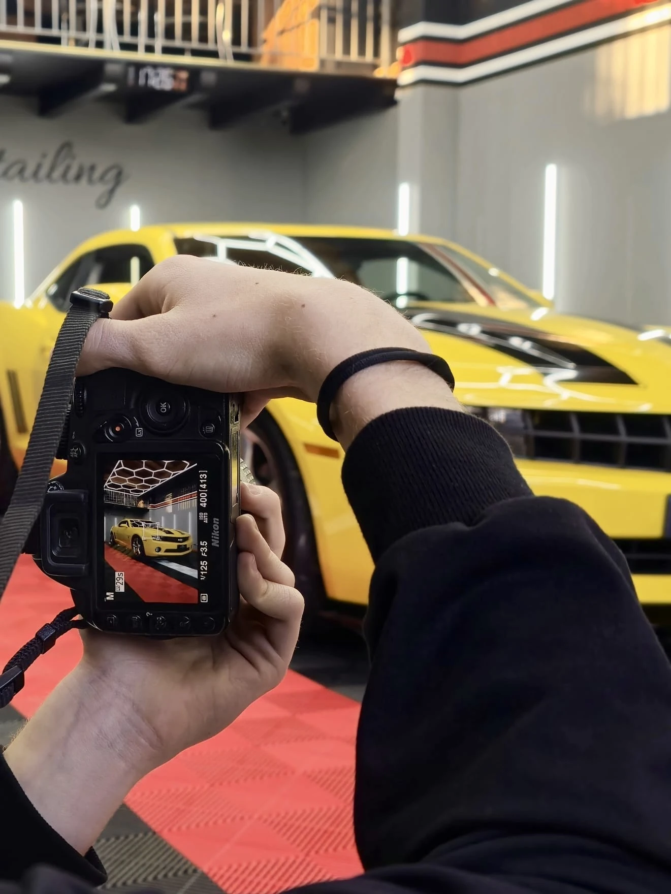 Lorenzo Giarnetti photographing a car on location, behind the scenes